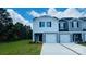 Charming two-story townhome with white and blue siding, a one-car garage, and a well-maintained front lawn at 1403 Old Rivers Rd, Concord, NC 28027