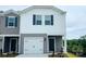 Charming townhome featuring a one-car garage and a welcoming front entrance at 1403 Old Rivers Rd, Concord, NC 28027