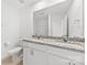 Bright bathroom featuring granite double vanity, white cabinets, and toilet at 15208 Caspian Way, Charlotte, NC 28278