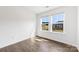 Sunlit bedroom featuring hardwood floors and a view of the neighborhood through large windows at 15208 Caspian Way, Charlotte, NC 28278
