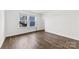 Bright bedroom features a window, door, and dark wood-look flooring at 15208 Caspian Way, Charlotte, NC 28278