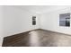 Bright bedroom featuring hardwood floors, a ceiling light, and large windows for natural light at 15208 Caspian Way, Charlotte, NC 28278
