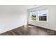 Bedroom with hardwood floors and two windows overlooking the neighborhood at 15208 Caspian Way, Charlotte, NC 28278