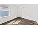 Bedroom with hardwood floors, closet, neutral walls, and a bright window at 15208 Caspian Way, Charlotte, NC 28278