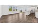 Open-concept kitchen and living room filled with natural light and hardwood flooring at 15208 Caspian Way, Charlotte, NC 28278