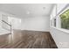 Bright, airy living room with hardwood floors and large windows overlooking a green landscape at 15208 Caspian Way, Charlotte, NC 28278