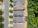 Aerial view of property in a suburban neighborhood, showing the roof, yard, and surrounding trees at 15524 Scholastic Dr, Charlotte, NC 28277