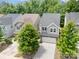 An aerial view showcases a two-story home nestled among mature trees in a well-developed residential neighborhood at 15524 Scholastic Dr, Charlotte, NC 28277