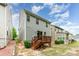 View of a backyard featuring a wooden deck and the side of a two-story home with light gray siding at 15524 Scholastic Dr, Charlotte, NC 28277