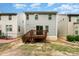 Back exterior of home featuring gray siding, a wooden deck, and a small yard at 15524 Scholastic Dr, Charlotte, NC 28277