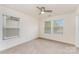 Bedroom featuring neutral carpet, natural light, a ceiling fan, and fresh white trim at 15524 Scholastic Dr, Charlotte, NC 28277