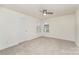 Bedroom with natural light, plush carpet, ceiling fan, and fresh white trim at 15524 Scholastic Dr, Charlotte, NC 28277