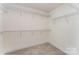 Walk-in closet with installed wire shelving for optimal storage and organization at 15524 Scholastic Dr, Charlotte, NC 28277