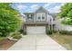 Charming two-story home with a two-car garage, beautiful landscaping, and a well-maintained lawn at 15524 Scholastic Dr, Charlotte, NC 28277