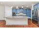 A modern kitchen with blue cabinets, stainless steel appliances, and a spacious island with seating at 15524 Scholastic Dr, Charlotte, NC 28277