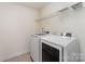 Laundry room featuring tiled floors and a washer and dryer at 15524 Scholastic Dr, Charlotte, NC 28277