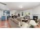 An open-concept living space with a fireplace, hardwood floors, and a modern kitchen with blue cabinets at 15524 Scholastic Dr, Charlotte, NC 28277
