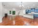 An open-concept living room flows into a kitchen with blue cabinets, a granite island, and stainless steel appliances at 15524 Scholastic Dr, Charlotte, NC 28277