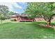The backyard of the home has a deck, green grass and a large tree at 158 Jane Sowers Rd, Statesville, NC 28625