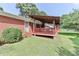 A cozy backyard featuring a covered deck and a lush, green lawn at 158 Jane Sowers Rd, Statesville, NC 28625
