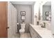 Well-lit bathroom with a shower, toilet, and sink with a vanity and white tiling at 158 Jane Sowers Rd, Statesville, NC 28625