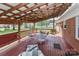 Wide covered deck featuring stained wood floor, outdoor furniture, ceiling fan, and view of a large yard at 158 Jane Sowers Rd, Statesville, NC 28625