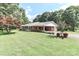 A charming home set on a lush green lawn with mature trees and shrubbery at 158 Jane Sowers Rd, Statesville, NC 28625
