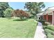 Beautiful home with a well-maintained front yard, mature trees, and sidewalk to the front door at 158 Jane Sowers Rd, Statesville, NC 28625