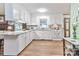 Bright kitchen featuring white cabinets, granite countertops, and stainless steel appliances at 158 Jane Sowers Rd, Statesville, NC 28625