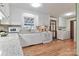 Well-lit kitchen featuring white cabinets, granite countertops, and access to the laundry area at 158 Jane Sowers Rd, Statesville, NC 28625