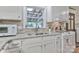 Bright kitchen featuring white cabinets, granite countertops, and stainless steel appliances at 158 Jane Sowers Rd, Statesville, NC 28625