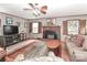 The living room has a brick fireplace, a ceiling fan, and large area rug at 158 Jane Sowers Rd, Statesville, NC 28625