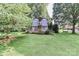 Charming custom playhouse with a unique design and lovely landscaping in the backyard at 158 Jane Sowers Rd, Statesville, NC 28625