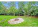 Enjoy the backyard with a built-in fire pit and mature trees at 16512 Kimbolten Dr, Huntersville, NC 28078