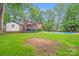 Expansive backyard featuring a pool, screened in porch and brick house at 16512 Kimbolten Dr, Huntersville, NC 28078