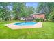 Serene backyard with in-ground pool, landscaped yard, deck and patio for relaxation and fun at 16512 Kimbolten Dr, Huntersville, NC 28078