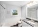 Bright bathroom with granite counters, white cabinets and a tub and shower with marble walls at 16512 Kimbolten Dr, Huntersville, NC 28078