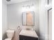 Clean, modern bathroom with a dark vanity, speckled countertop, and a neutral color palette for a soothing atmosphere at 16512 Kimbolten Dr, Huntersville, NC 28078