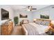 Cozy bedroom with wood furniture, art, ceiling fan and neutral colors at 16512 Kimbolten Dr, Huntersville, NC 28078