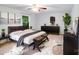 Sizable bedroom with dark furniture, ceiling fan, decorative plants and large window at 16512 Kimbolten Dr, Huntersville, NC 28078
