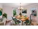 Elegant dining room with a wooden table, six chairs, and natural light, perfect for Gathering meals and gatherings at 16512 Kimbolten Dr, Huntersville, NC 28078
