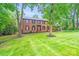 Beautiful brick home featuring well-maintained landscaping, a vibrant lawn, and a classic, timeless design at 16512 Kimbolten Dr, Huntersville, NC 28078