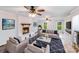 Cozy living room with a white brick fireplace, comfortable seating, and natural light, perfect for relaxing and entertaining at 16512 Kimbolten Dr, Huntersville, NC 28078