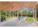 Relaxing screened porch with wood ceiling and fan, offering a view of the swimming pool at 16512 Kimbolten Dr, Huntersville, NC 28078