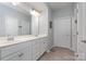 Bathroom has a dual sink vanity, large mirror, white cabinets, and a tiled floor at 1663 Tranquility Blvd, Lancaster, SC 29720