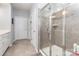 Modern bathroom features a glass-enclosed shower with tiled walls and a tiled accent stripe at 1663 Tranquility Blvd, Lancaster, SC 29720