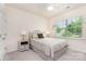 Cozy bedroom with neutral tones, a comfortable bed, and natural light from the window at 1663 Tranquility Blvd, Lancaster, SC 29720