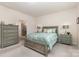 This bedroom is complete with matching bedside tables, lamps, and an attached bathroom at 1663 Tranquility Blvd, Lancaster, SC 29720