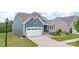 Attractive home with blue siding, stone accents, landscaped lawn, and two car garage at 1663 Tranquility Blvd, Lancaster, SC 29720