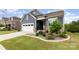 Beautiful home with blue siding, stone accents, landscaped lawn, and two car garage at 1663 Tranquility Blvd, Lancaster, SC 29720